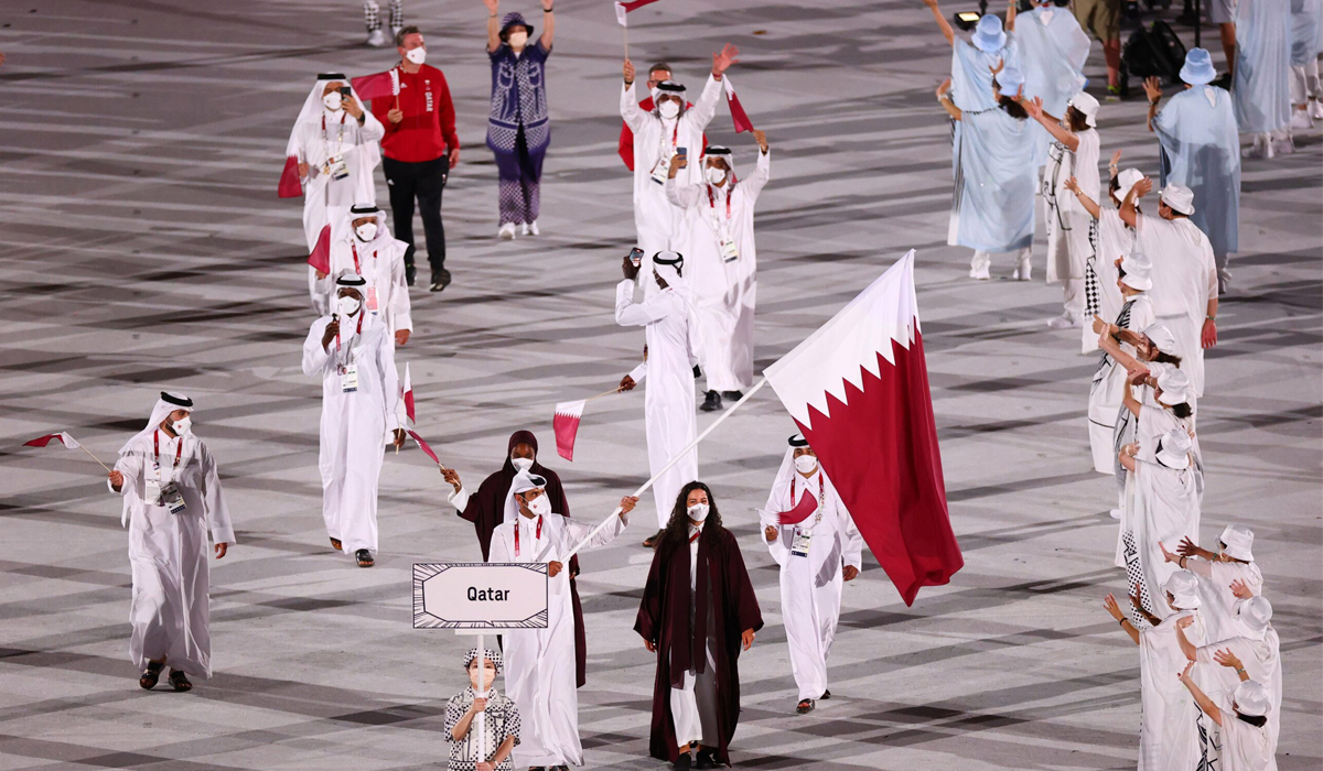 Abujbara and Al Rumaihi carry Qatari flag during opening ceremony of Tokyo Olympics